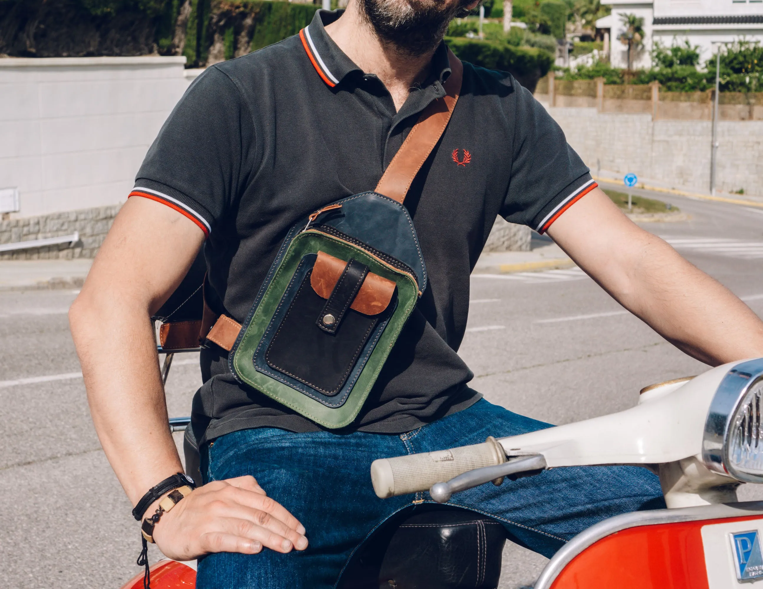 Men's crossbody bag featuring green, brown, blue, black leather and multiple pockets