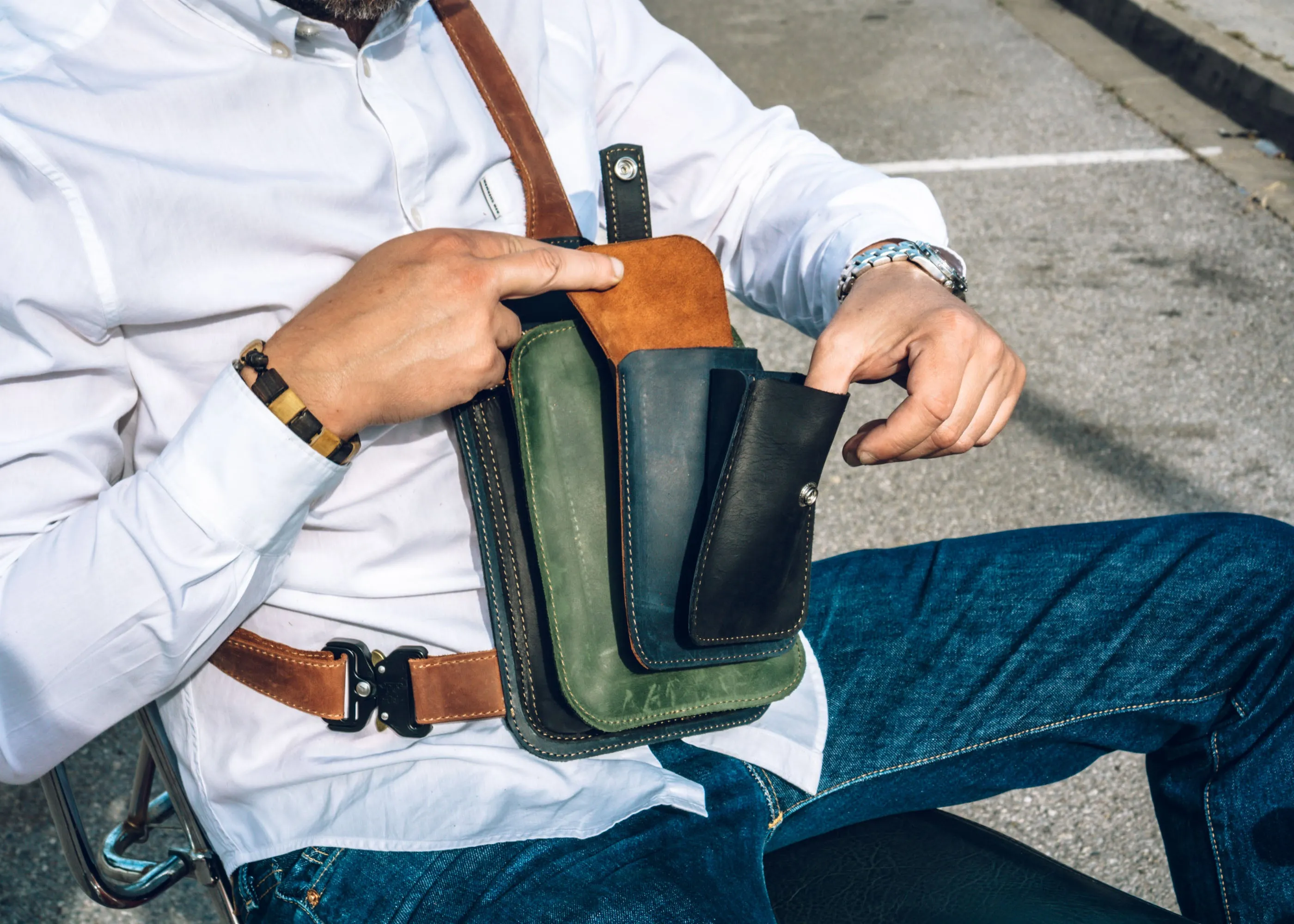 Men's crossbody bag featuring green, brown, blue, black leather and multiple pockets