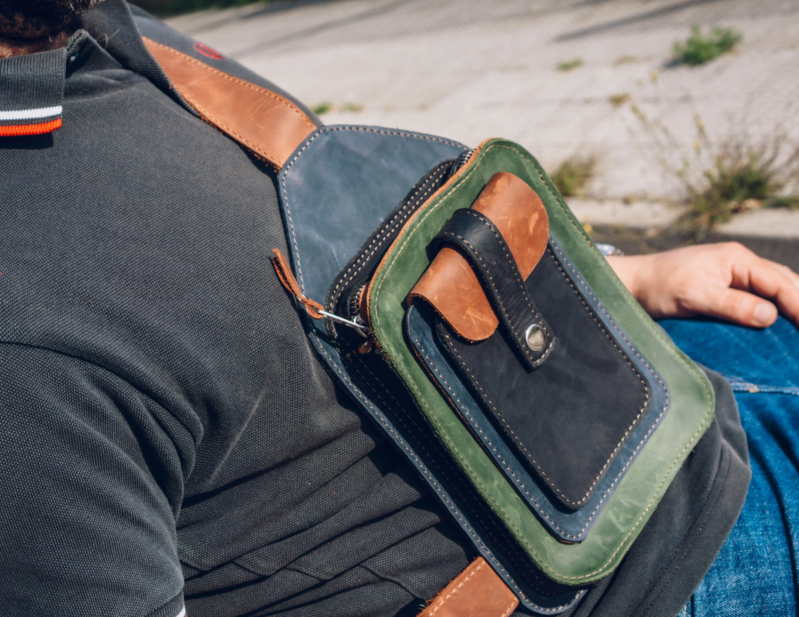 Men's crossbody bag featuring green, brown, blue, black leather and multiple pockets